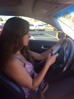 Oxnard High School senior Mary Allison Ihrke demonstrates texting and driving.
