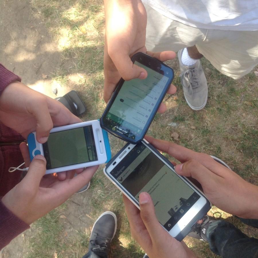  Students at Oxnard High School access social media through their smartphones.